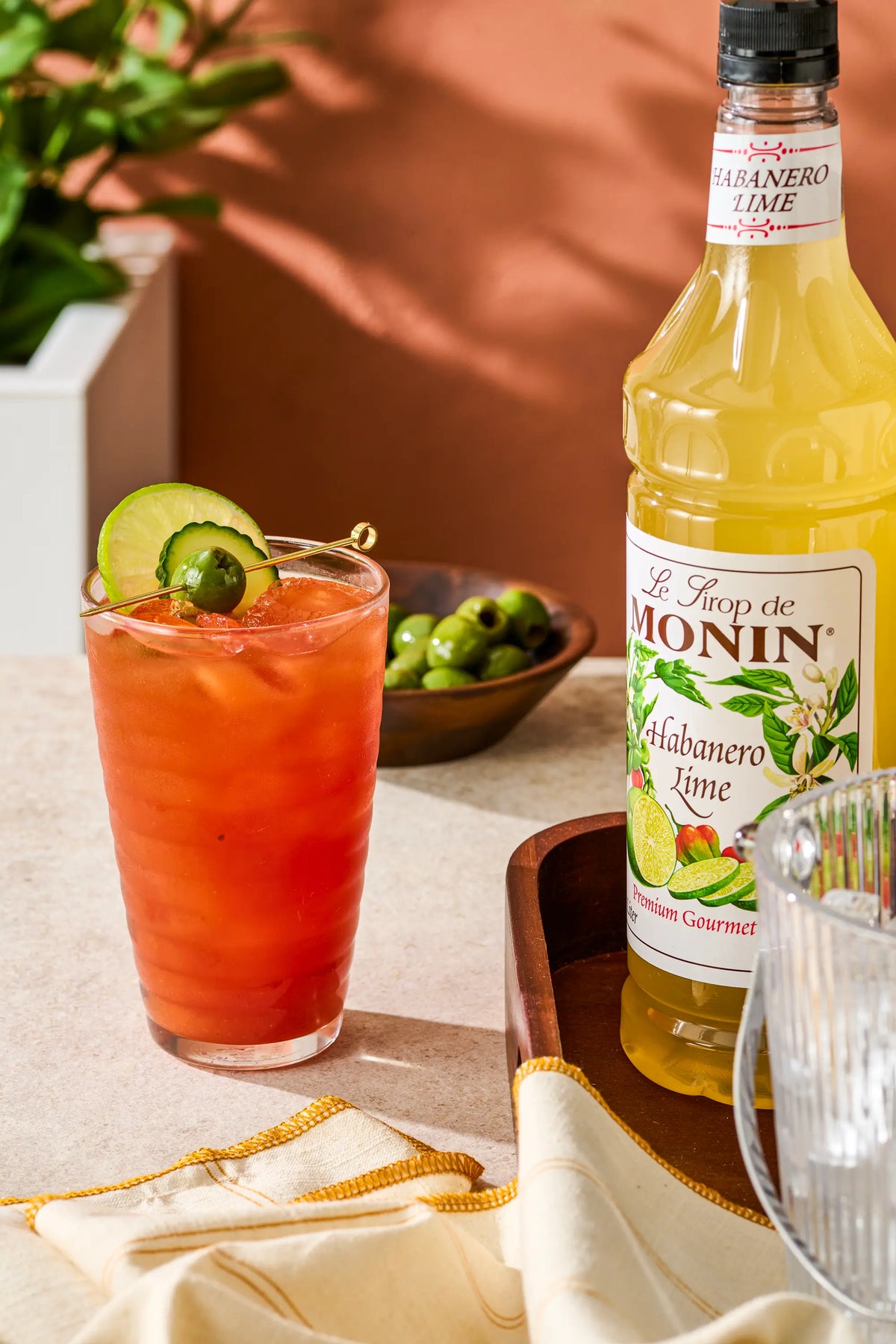 Monin Habanero Lime Syrup with spicy lime cocktail, lime slices and pepper garnish