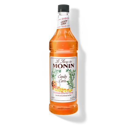 A bottle of Monin Candy Corn Syrup with a label showing the product name and an image of candy corn.