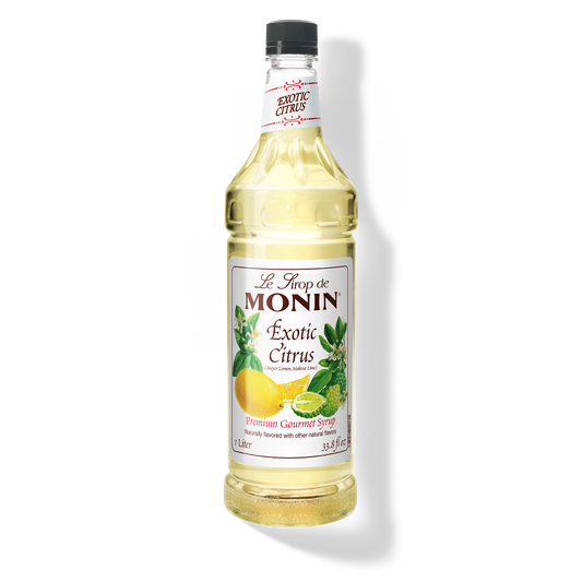 A bottle of Monin Exotic Citrus Syrup with a label showing the brand name and the flavor, placed against a white background.
