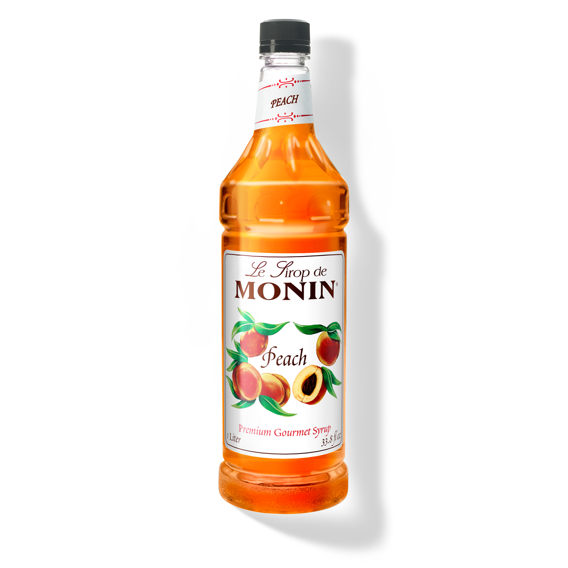 A 1L bottle of Monin Peach Syrup showing the brand name and flavour, placed against a white background
