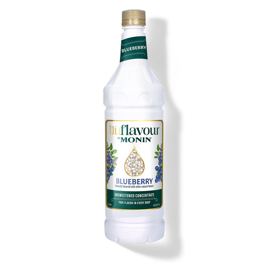 Monin Blueberry syrup bottle on a white background