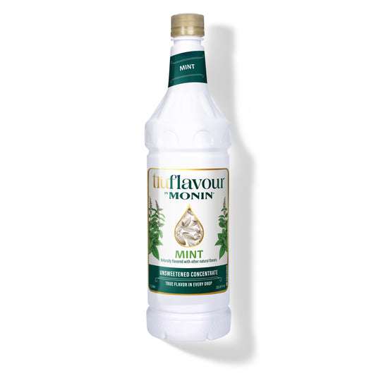 Monin Mint syrup bottle on a white background