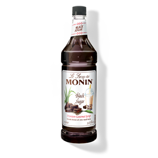 A bottle of Monin Black Sugar Syrup, with a label showing the brand name and the syrup's name.