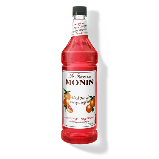 A bottle of Monin Blood Orange Syrup with a label showing an image of a blood orange. The bottle is transparent, showing the bright red syrup inside.
