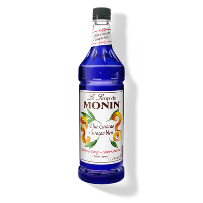 A bottle of Monin Blue Curacao syrup, featuring a vibrant blue color.