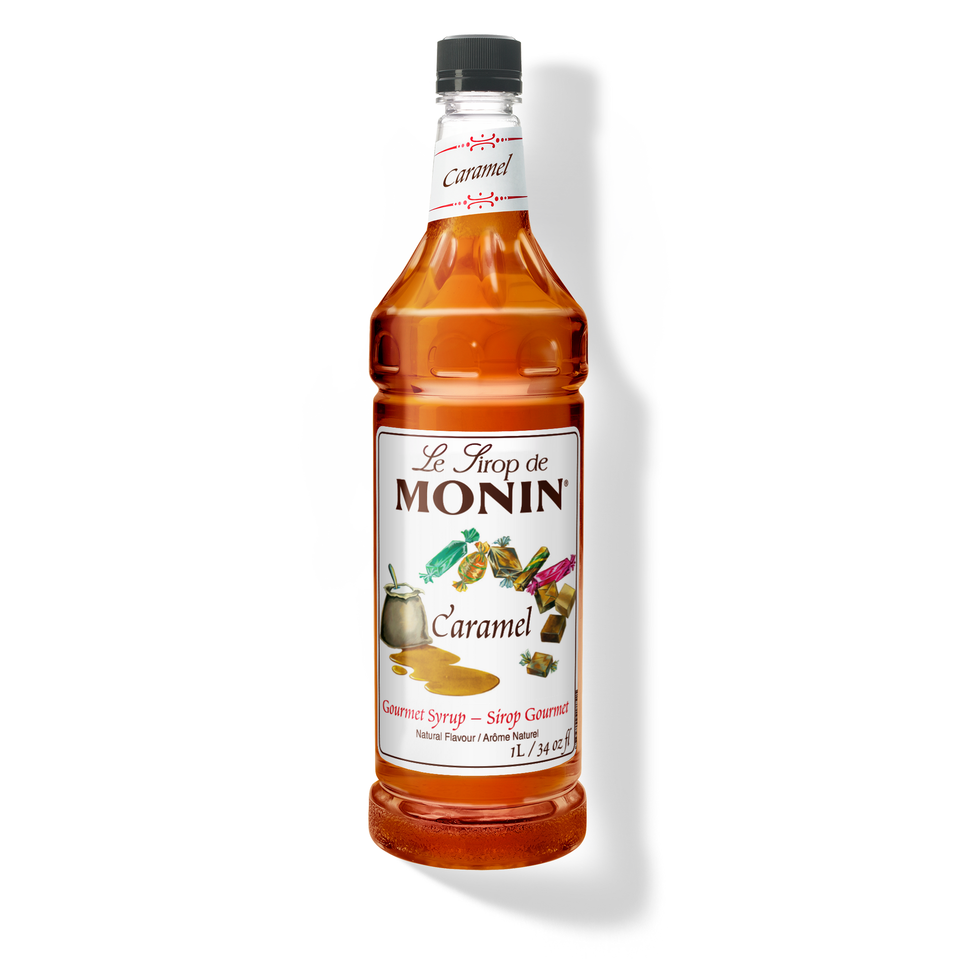 A bottle of Monin caramel syrup on a plain white background. The clear bottle shows the amber liquid inside and has a white label with the brand name.