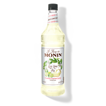 A bottle of Monin Key Lime Pie Syrup with a label showing the brand name and the flavor, placed against a white background.