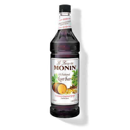 A bottle of Monin Old Fashioned Root Beer Syrup with a label showing the brand name and the flavor, placed against a white background.
