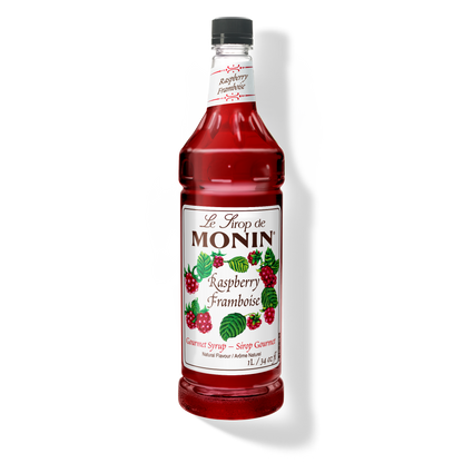 A 1L-bottle of Monin Raspberry Syrup with a label showing the brand name and the flavor, placed against a white background.
