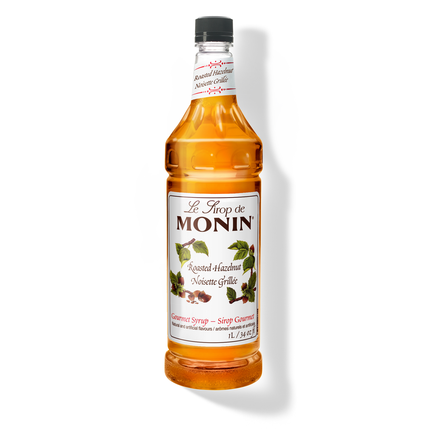 A 1L-bottle of Monin Roasted Hazelnut Syrup with a label showing the brand name and the flavor, placed against a white background.
