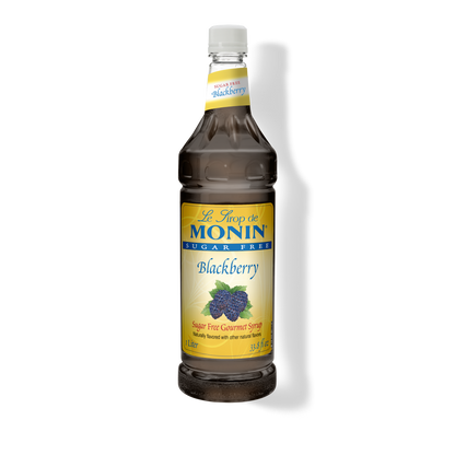 A bottle of Monin Sugar Free Blackberry Syrup with a label showing blackberries and the text 'Blackberry' on it.