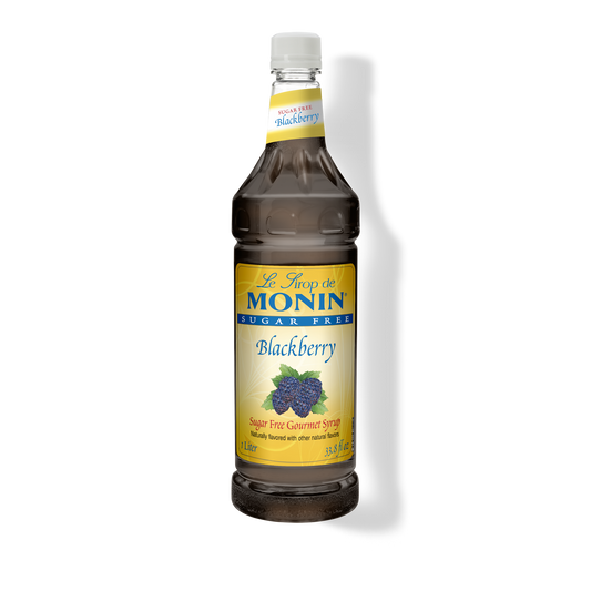 A bottle of Monin Sugar Free Blackberry Syrup with a label showing blackberries and the text 'Blackberry' on it.