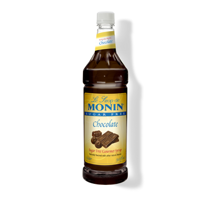 A bottle of Monin Sugar Free Chocolate Syrup, with a label showing the brand name and the product name, placed against a plain background.