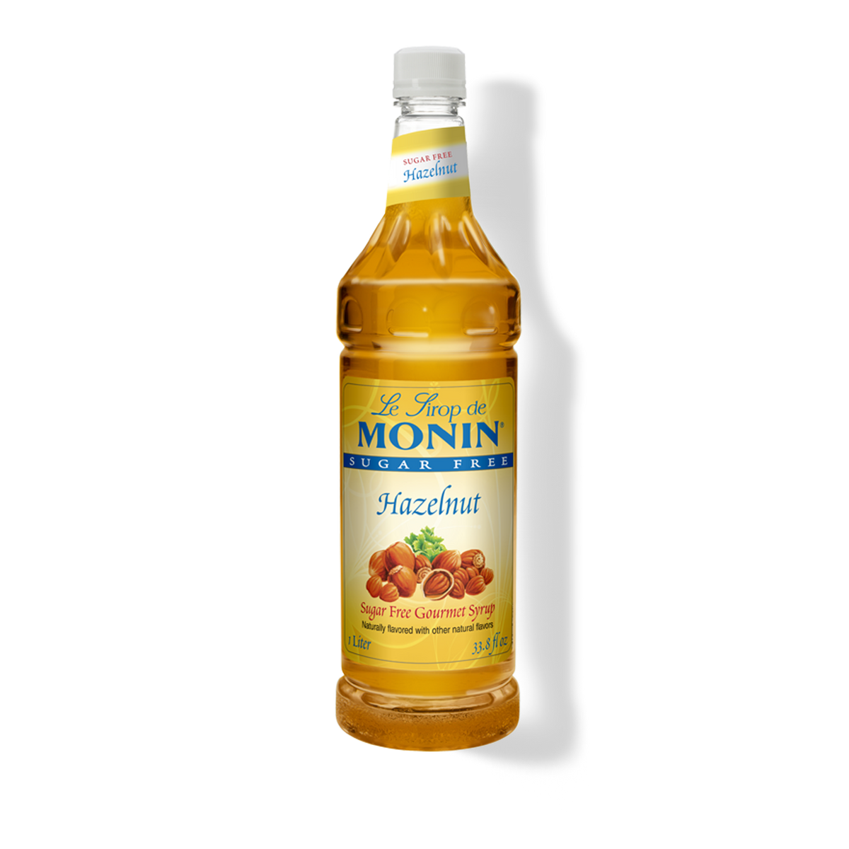 A bottle of Monin Sugar Free Hazelnut Syrup, with a yellow label displaying the product name and an image of hazelnuts.