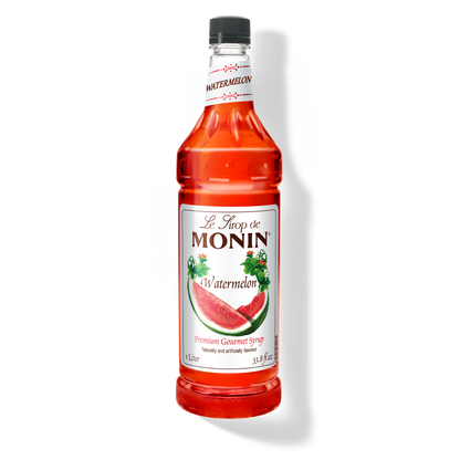 A bottle of Monin Watermelon Syrup with a label showing a watermelon slice, indicating the flavor of the syrup.