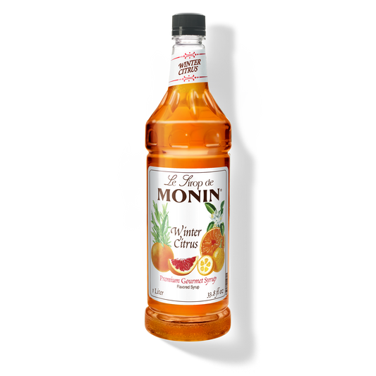 A bottle of Monin Winter Citrus Syrup with a label showing the brand name and the flavor, placed against a white background.