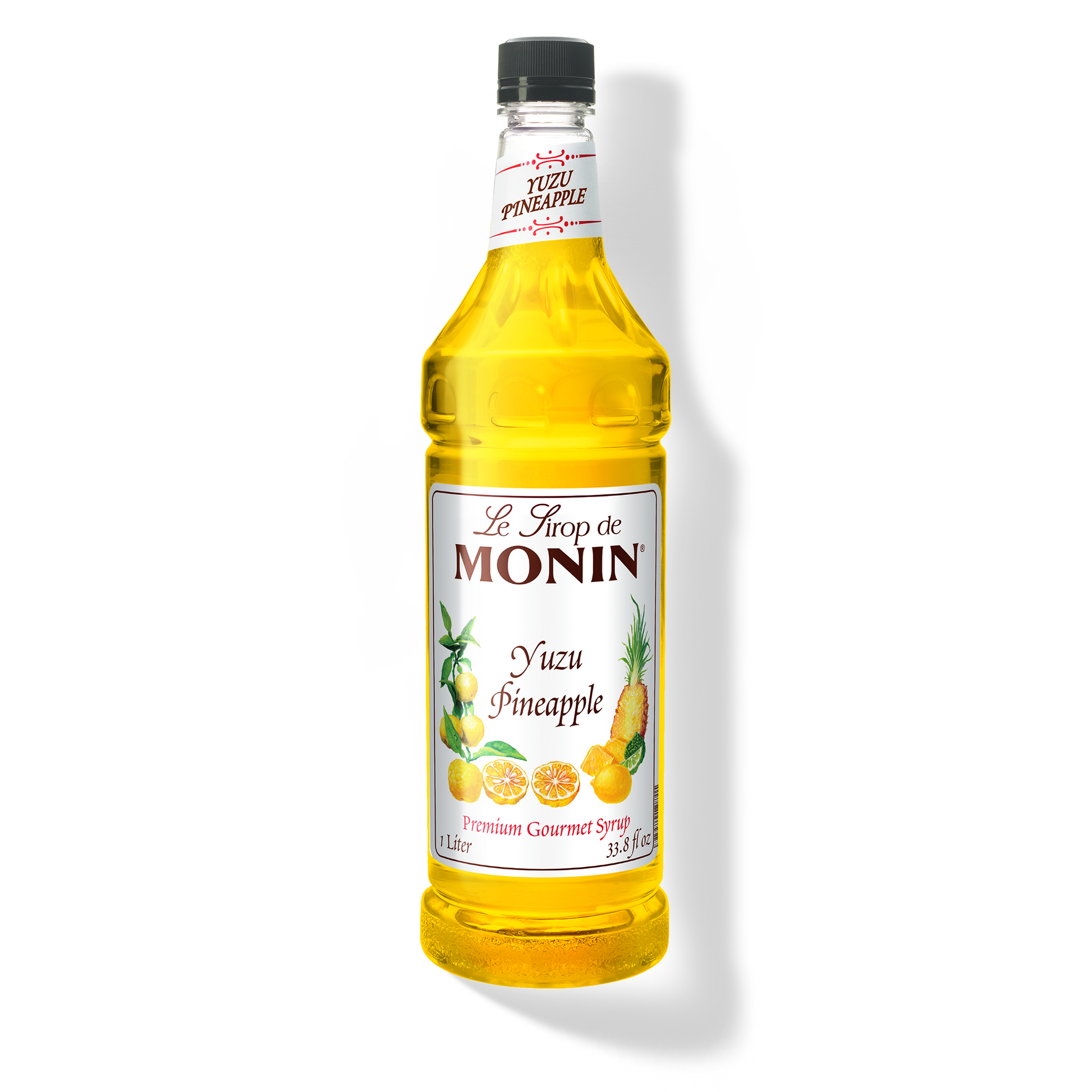 A bottle of Monin Yuzu Pineapple Syrup with a yellow liquid