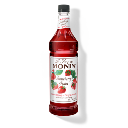 A 1L-bottle of Monin Strawberry Syrup with a label showing the brand name and the flavor, placed against a white background.
