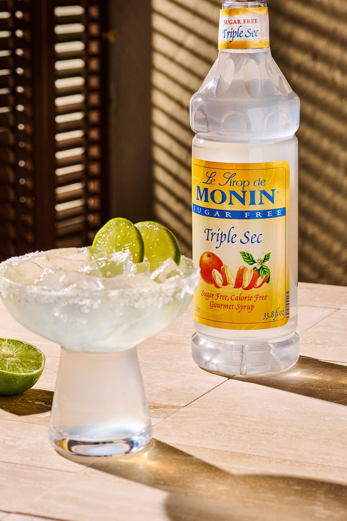 Monin Sugar Free Triple Sec Syrup with a margarita, lime garnish and salted rim