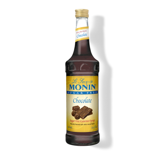 A bottle of Monin Sugar Free Chocolate Syrup, with a label showing the brand name and the product name, placed against a plain background.