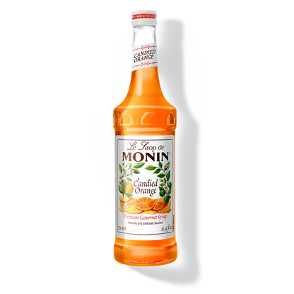 A 750mL-bottle of Monin Candied Orange Syrup with a label showing an orange slice and green leaves, indicating the flavor of the syrup.