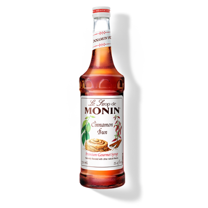 Bottle of Monin Cinnamon Bun syrup on a white background