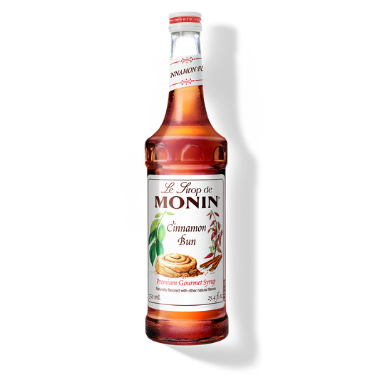Bottle of Monin Cinnamon Bun syrup on a white background