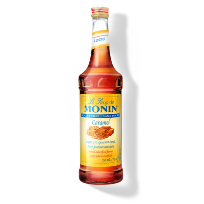 A bottle of Monin Sugar Free Caramel Syrup, with a label showing a piece of caramel candy.