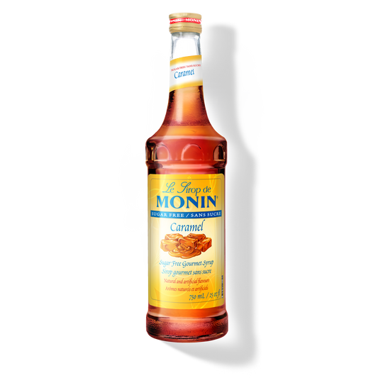 A bottle of Monin Sugar Free Caramel Syrup, with a label showing a piece of caramel candy.