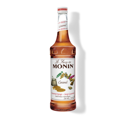 A bottle of Monin Caramel Syrup with the label displaying the product name and an image of a caramel candy.