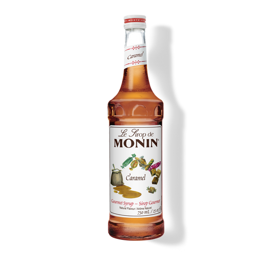 A bottle of Monin Caramel Syrup with the label displaying the product name and an image of a caramel candy.