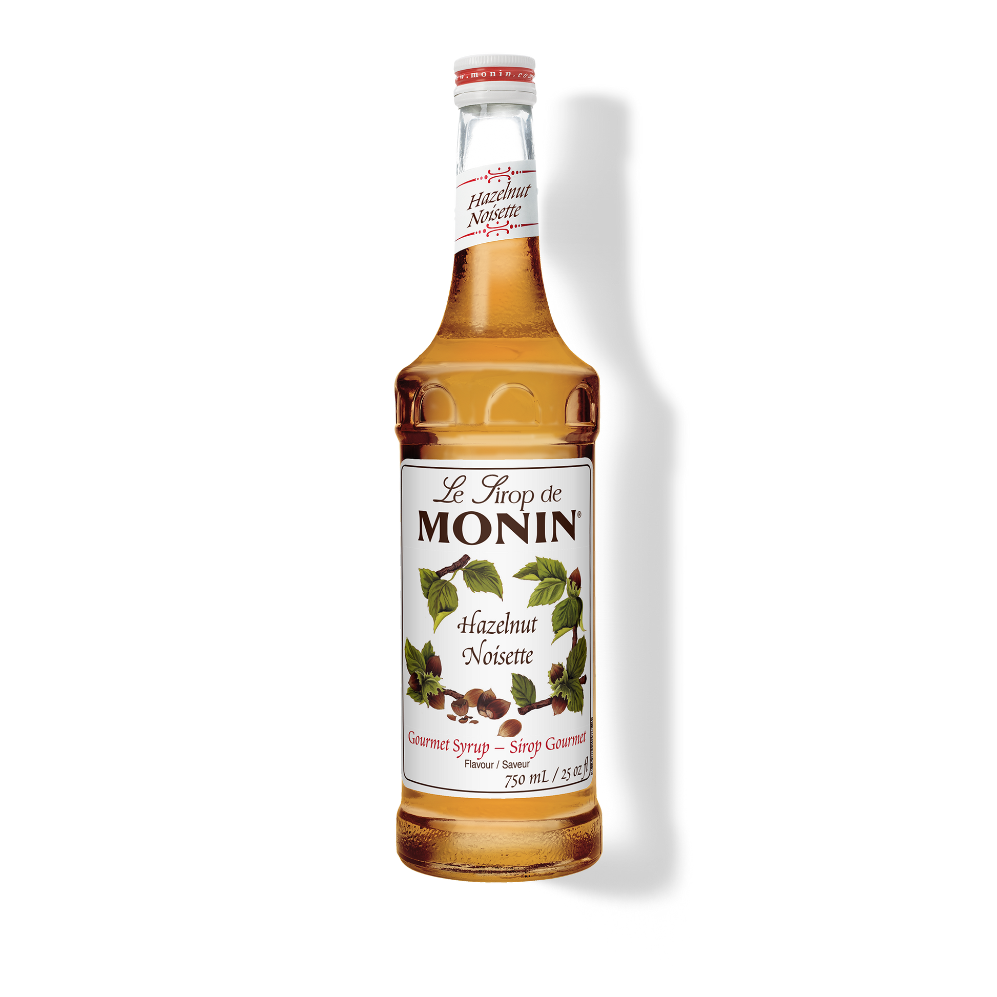 A 750mL-bottle of Monin Hazelnut Syrup with a label showing the brand name and the flavor, placed against a white background.