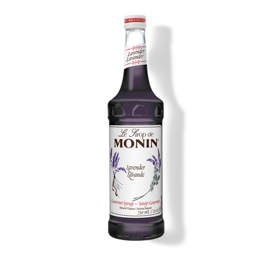 A bottle of Monin Lavender Syrup with a label showing the brand name and the flavor, placed against a white background.