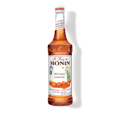 A 750mL-bottle of Monin Salted Caramel Syrup with a label showing the brand name and the flavor, placed against a white background.