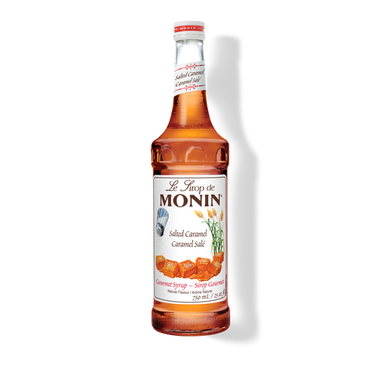 A 750mL-bottle of Monin Salted Caramel Syrup with a label showing the brand name and the flavor, placed against a white background.