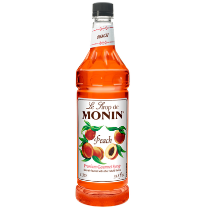 Monin Peach syrup bottle on a white background