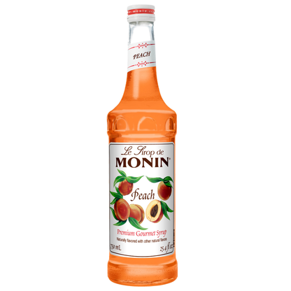Monin Peach syrup bottle on a white background