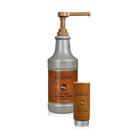 A bottle of Monin Sea Salt Caramel Toffee Sauce beside a 12oz squeeze bottle of the sauce.