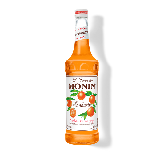 A bottle of Monin Mandarin Syrup with a label showing the brand name and the flavor, placed against a white background.