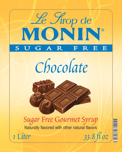 Front of Monin Sugar Free Chocolate syrup package, showing a yellow label with blue and red text and an illustration of chocolate bars and chocolates.