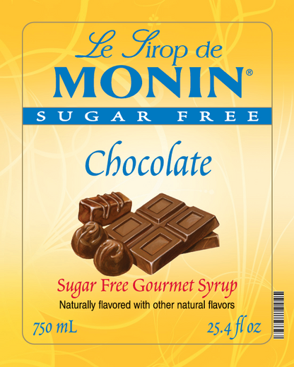 Front of Monin Sugar Free Chocolate syrup package, showing a yellow label with blue and red text and an illustration of chocolate bars and chocolates.