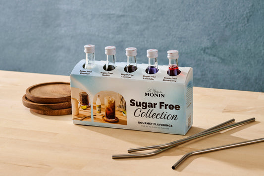 Monin Sugar Free Collection packaging with bottles on a wooden surface