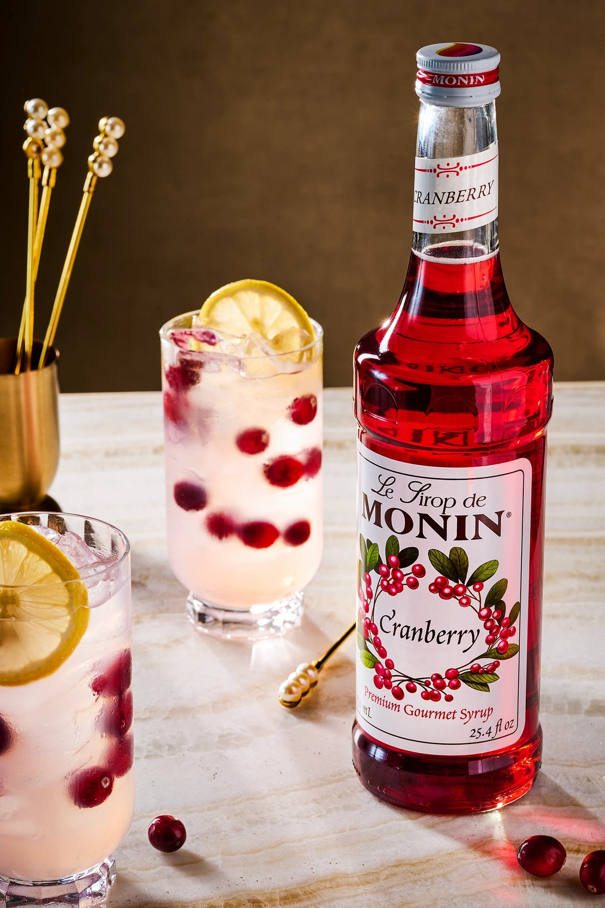 Monin Cranberry Syrup with cranberry lemon drinks and fresh cranberries