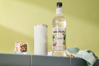 Monin Cupcake Syrup with a creamy drink topped with colourful sprinkles