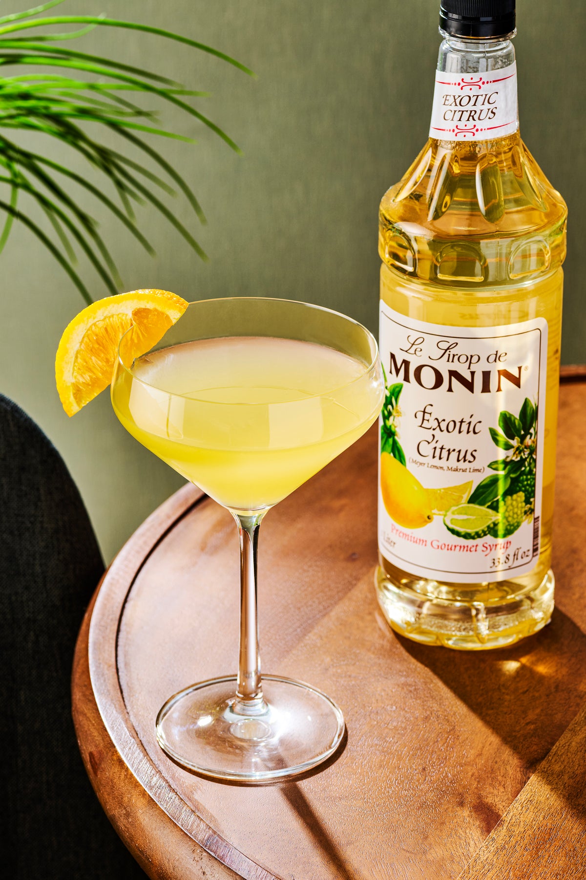 Monin Exotic Citrus Syrup with citrus cocktail and orange garnish