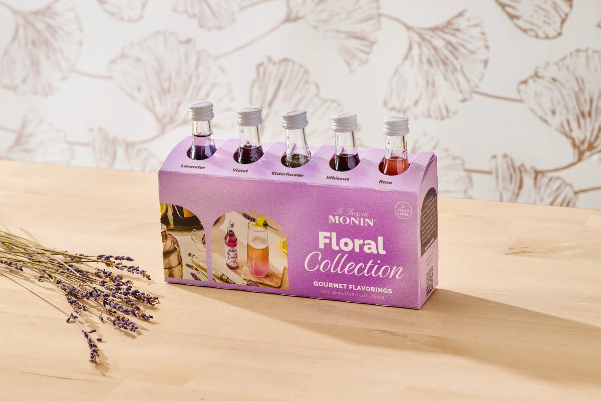 Monin Floral Collection sample pack with five floral syrup flavours and dried lavender on a table