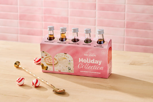 Monin Holiday Collection sample pack with five festive syrup flavours, peppermint candies and cocktail spoon
