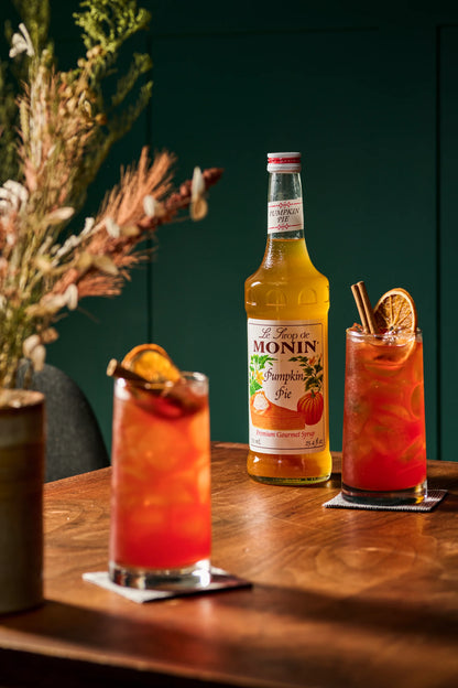 Monin Pumpkin Pie Syrup featured with a fall-inspired iced cocktail, highlighting rich pumpkin flavour with warm seasonal notes.
