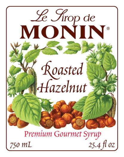 750mL Monin Roasted Hazelnut Syrup label showing the brand name and hazelnut illustrations.